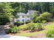 Charming two-story home with a well-manicured lawn, lush landscaping, and a driveway at 1172 Colony Dr, Marietta, GA 30068