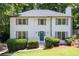 Charming two-story home with a well-manicured lawn, featuring a classic white facade and gray shutters at 1172 Colony Dr, Marietta, GA 30068