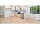 A view of the newly renovated kitchen with stainless steel appliances and custom white cabinets at 1172 Colony Dr, Marietta, GA 30068