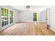 Bright living room with hardwood floors, large windows, and white trim, offering a spacious and airy feel at 1172 Colony Dr, Marietta, GA 30068