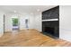 Spacious living room showcases a stone fireplace, beautiful hardwood floors, and access to the outdoor space at 1172 Colony Dr, Marietta, GA 30068
