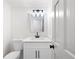 A half-bathroom featuring a new vanity with quartz countertops and modern black hardware and lighting at 1172 Colony Dr, Marietta, GA 30068