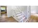 A wide staircase leading to the upper level features new hardwood floors and a fresh coat of paint at 1172 Colony Dr, Marietta, GA 30068