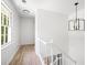 An upstairs hallway featuring hardwood floors, fresh paint, and modern lighting at 1172 Colony Dr, Marietta, GA 30068