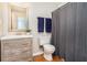 Bathroom features a wood vanity, wood floor, and a gray shower curtain at 1902 Seals Rd, Dallas, GA 30157