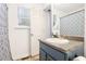 Bathroom with a vanity with granite countertop, patterned shower curtain, and a modern mirror at 1902 Seals Rd, Dallas, GA 30157