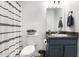 Bathroom features a white toilet, a striped shower curtain and blue vanity at 1902 Seals Rd, Dallas, GA 30157