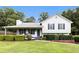 Charming home with a welcoming front porch, manicured hedges, and lush green lawn at 1902 Seals Rd, Dallas, GA 30157