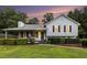 Charming home exterior with a well manicured lawn and manicured landscaping at 1902 Seals Rd, Dallas, GA 30157