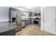 Well-equipped kitchen with stainless steel appliances, blue cabinets, and bright lighting at 1902 Seals Rd, Dallas, GA 30157