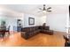 Open-concept living room featuring hardwood floors, a cozy leather sectional, and stairs to second floor at 1902 Seals Rd, Dallas, GA 30157