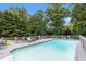 Backyard inground pool with surrounding deck and lounge chairs at 1902 Seals Rd, Dallas, GA 30157