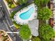 Aerial view of a community swimming pool with plenty of lounge chairs and lush greenery around the edge at 2305 Limehurst Ne Dr # 21, Atlanta, GA 30319