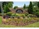 Attractive community entrance with stone signage and lush landscaping at Lenox Crossing at 2305 Limehurst Ne Dr # 21, Atlanta, GA 30319