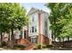 Attractive three-story townhome featuring brick facade, multiple windows, and landscaped entry at 2305 Limehurst Ne Dr # 21, Atlanta, GA 30319