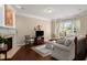 Bright living room with fireplace, hardwood floors, neutral paint, and a wall of large windows at 2305 Limehurst Ne Dr # 21, Atlanta, GA 30319