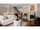 Cozy living room with fireplace, hardwood floors, neutral paint and comfortable seating at 2305 Limehurst Ne Dr # 21, Atlanta, GA 30319