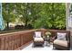 Outdoor patio space with seating overlooking green backyard filled with mature trees at 2305 Limehurst Ne Dr # 21, Atlanta, GA 30319