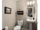 Charming powder room featuring pedestal sink, decorative mirror, and neutral paint at 2305 Limehurst Ne Dr # 21, Atlanta, GA 30319