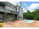 Rear exterior view of a two-story home with a swimming pool and large patio at 5755 Riley Rd, Cumming, GA 30028