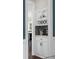 Coffee bar with overhead cabinets, glass door inserts and decorative backsplash at 5755 Riley Rd, Cumming, GA 30028