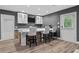This bar features pendant lighting, a stone facade, seating for three, and a modern faucet at 5755 Riley Rd, Cumming, GA 30028