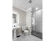 Modern bathroom with a glass-enclosed shower, pedestal sink, and sleek fixtures at 5755 Riley Rd, Cumming, GA 30028