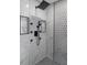 This modern bathroom features a rain shower, sleek fixtures, and elegant marble and mosaic tile work at 5755 Riley Rd, Cumming, GA 30028