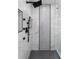 This modern bathroom features a rain shower, sleek fixtures, and elegant marble and mosaic tile work at 5755 Riley Rd, Cumming, GA 30028