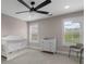 Bright Bedroom with a white crib, changing table, shuttered windows, and a ceiling fan at 5755 Riley Rd, Cumming, GA 30028