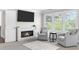 Bright bedroom featuring a fireplace, TV, and comfortable seating area with a large window at 5755 Riley Rd, Cumming, GA 30028