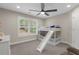 Cozy ' bedroom featuring a bunk bed with a slide, a ceiling fan, and a bright window at 5755 Riley Rd, Cumming, GA 30028