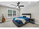 This bedroom features a ceiling fan, a guitar, and natural light from the lovely window at 5755 Riley Rd, Cumming, GA 30028