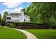 Beautiful two-story home featuring a rear deck, fenced yard, and a well-maintained lawn with pathway at 5755 Riley Rd, Cumming, GA 30028