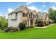 Charming brick home with well-maintained landscaping, featuring a covered porch, and lush green lawn at 5755 Riley Rd, Cumming, GA 30028