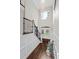 Bright foyer with soaring ceilings, staircase, beautiful chandelier, and elegant double doors at 5755 Riley Rd, Cumming, GA 30028