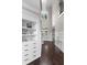 Elegant foyer featuring a chandelier, built-in shelving, and dark wood floors at 5755 Riley Rd, Cumming, GA 30028