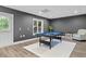 A game room features a billiards table and an exterior door to a backyard at 5755 Riley Rd, Cumming, GA 30028