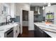 Well-lit kitchen featuring stainless steel appliances, marble countertops, and a stylish island at 5755 Riley Rd, Cumming, GA 30028