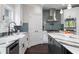 Bright kitchen showcasing white cabinets, stainless steel appliances, a stylish island and backsplash at 5755 Riley Rd, Cumming, GA 30028