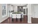 Modern kitchen with stainless steel appliances, white cabinetry, and island seating at 5755 Riley Rd, Cumming, GA 30028