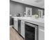 Modern kitchen with light countertops, stainless steel appliances, and a wine cooler at 5755 Riley Rd, Cumming, GA 30028