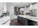 Modern kitchen with a stainless steel fridge, an island, white cabinets, and elegant marble countertops at 5755 Riley Rd, Cumming, GA 30028