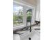 Bright kitchen with white cabinets, view of the yard and professional faucet at 5755 Riley Rd, Cumming, GA 30028