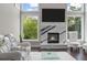 Cozy living room with modern fireplace and large windows overlooking greenery at 5755 Riley Rd, Cumming, GA 30028