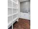 Walk-in pantry features open shelving, hardwood floors, and a convenient sink area at 5755 Riley Rd, Cumming, GA 30028