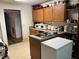 Functional kitchen featuring wooden cabinets, laminate countertops and flooring, and essential appliances for meal preparation at 7513 Sugarcreek Dr, Riverdale, GA 30296