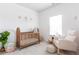 Charming Bedroom with wood crib, rocking chair, and decor at 137 Prominence Ct, Canton, GA 30114