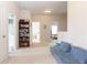 Carpeted hallway with bookshelf and adjacent rooms at 137 Prominence Ct, Canton, GA 30114