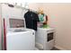 Laundry room with front load washer and dryer and storage at 137 Prominence Ct, Canton, GA 30114